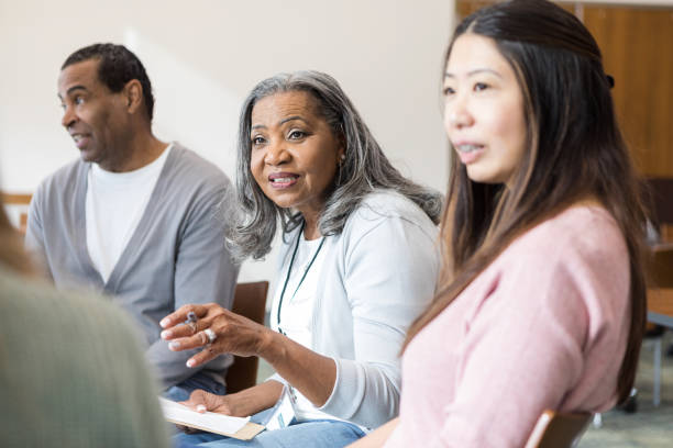 Before starting support group meeting, leader meets new member