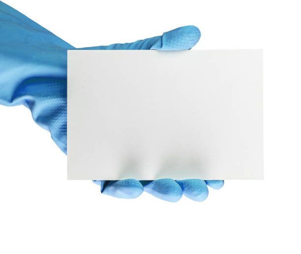 istock Blank gift card mockup for cleaning service ad. Hand in blue gloves holding empty certificate mock-up isolated on white background 1471422771