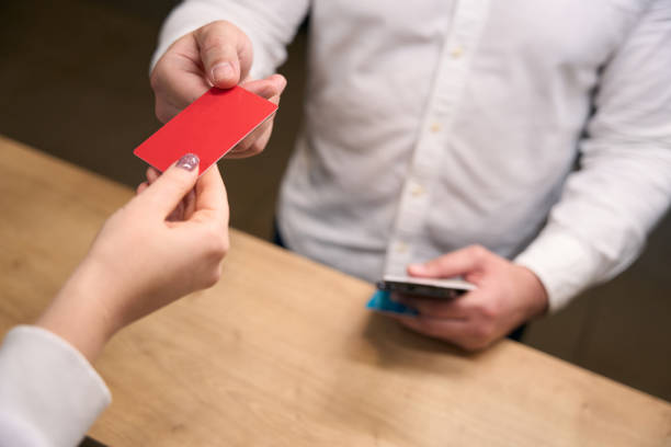 istock Businessperson getting key card from female receptionist 1471423607