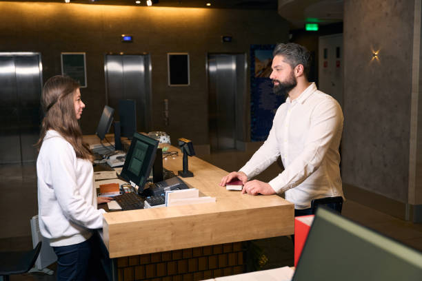 istock Businessman checking into hotel at front desk 1471423639
