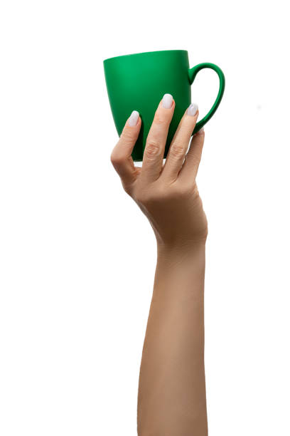 istock Coffee cup background. Female hand holding a coffee cup isolated on white background with clipping path. Close-up image. Coffee break time concept. 1471424985