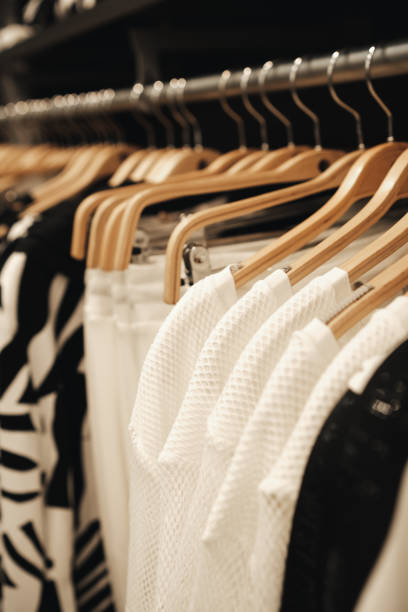 istock Clothes on hangers in a store. 1471425346