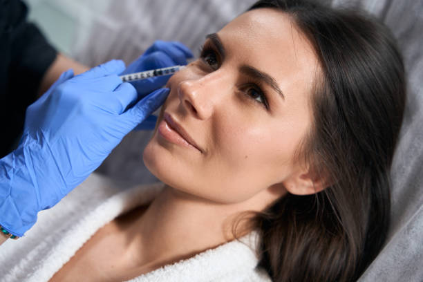 istock Lady doing face anti-aging injections in salon 1471428731