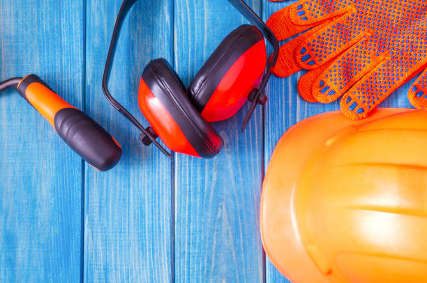 istock Orange hard hat and tool on wooden vintage blue boards 1471428771