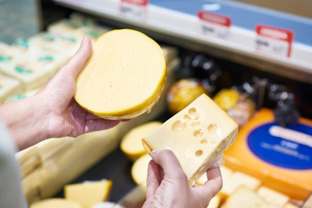 istock Buyer chooses cheese in store 1471429871