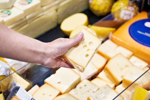istock Buyer chooses cheese in store 1471430027