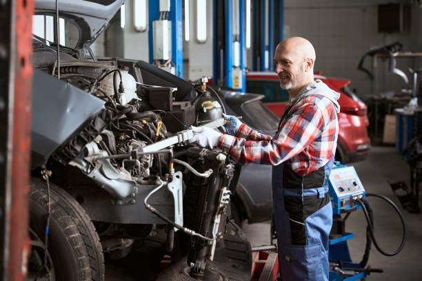 istock Middle-aged man stands in front of a dismantled car 1471432124