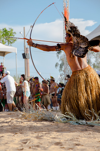 Cuiabá, MT, Brazil - November, 13, 2013 - indigenous man shooting with a bow and arrow at the XII games of indigenous peoples