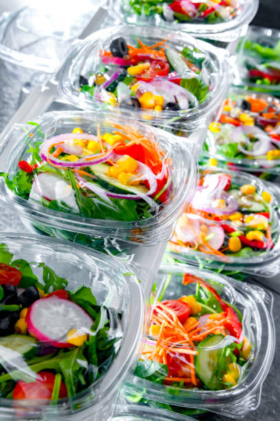 boxes with pre-packaged vegetable salads in a commercial fridge - packaged food imagens e fotografias de stock