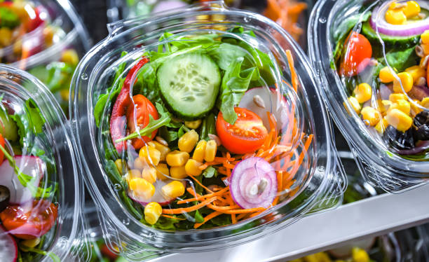 Boxes with pre-packaged vegetable salads in a commercial fridge Plastic boxes with pre-packaged vegetable salads, put up for sale in a commercial refrigerator convenience food stock pictures, royalty-free photos & images