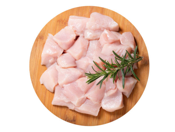 fresh chicken meat with rosemary on wooden board isolated on white background stock photo