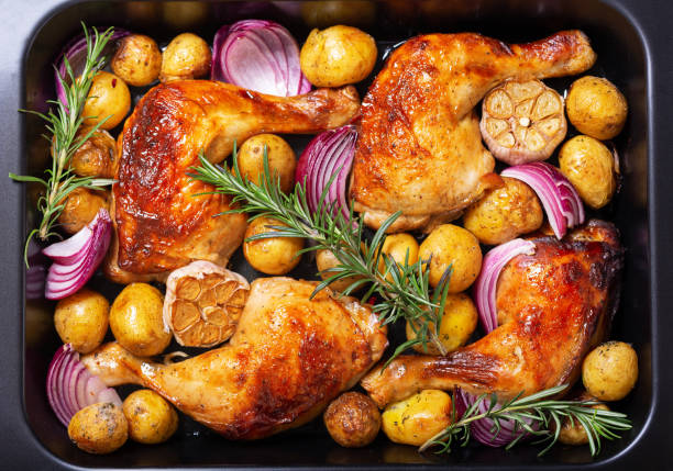 istock Chicken legs with potatoes and rosemary in a baking dish as background 1471438217