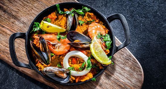 Seafood paella served in a cast iron pan.
