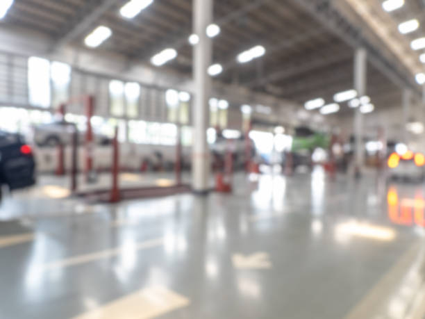 istock Abstract blur car garage automobile interior. Blurred mechanic service centre auto repair workshop, soft defocused. Blurry car care station background. 1471445504