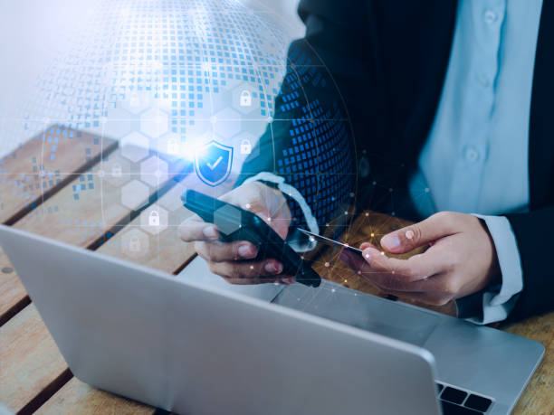 istock Secure payment concept. Security shield icon and lock symbol hologram appear while business people use mobile smart phone purchase with credit card in hand for online shopping and banking transaction. 1471446083