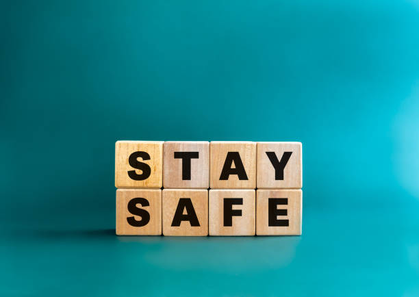 istock Stay safe concept. Word Stay Safe on wooden cube block stack isolated on aqua blue background, minimal style. Stay at home, social media campaign for covid-19 or coronavirus pandemic prevention. 1471446087