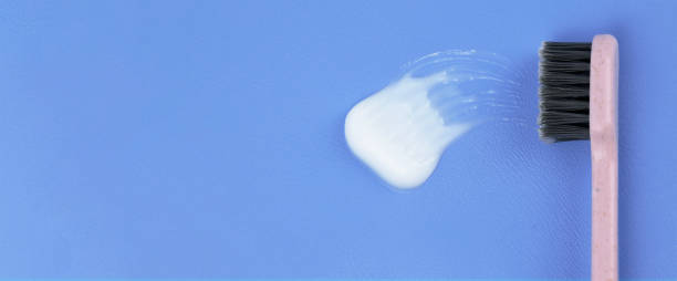 istock Toothbrush and toothpaste on a blue background. top view. Banner moke up 1471446548
