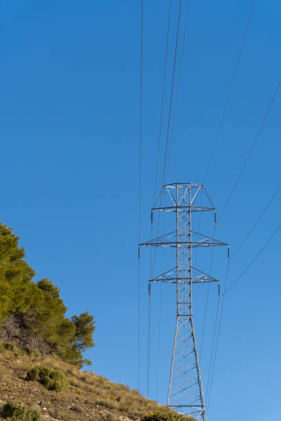 istock High voltage pylons on a sunny morning with blue sky 1471447041
