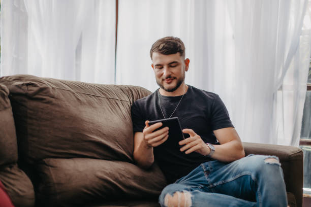 istock enjoying his new home sitting on sofa using tablet 1471447094