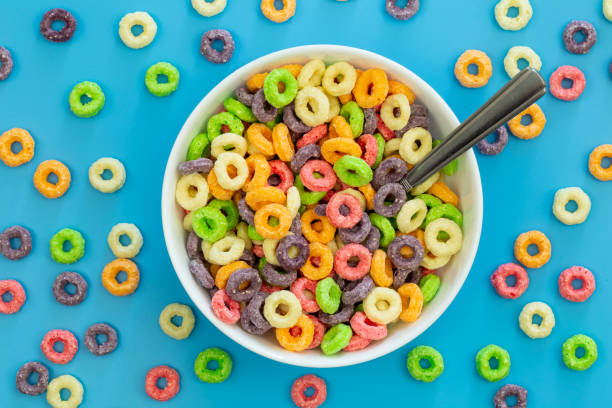 istock Colored breakfast cereal in a bowl on a blue background, flat lay. 1471449755