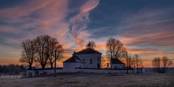 Winter sunset with color sky near Andelska Hora village with ruins and chapel stock photo