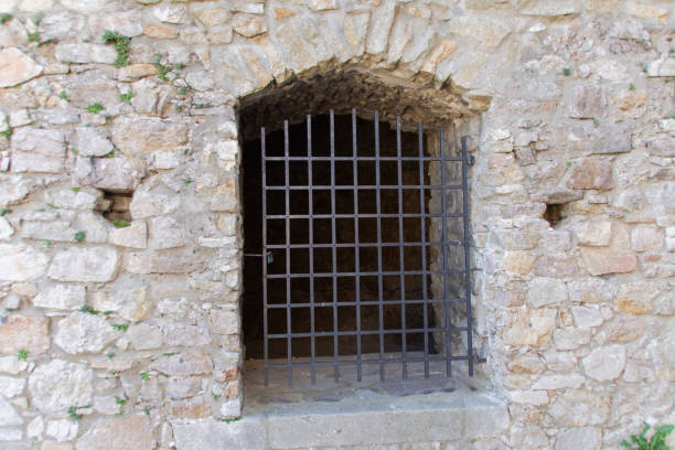 istock Barred entrance in an old wall 1471451386
