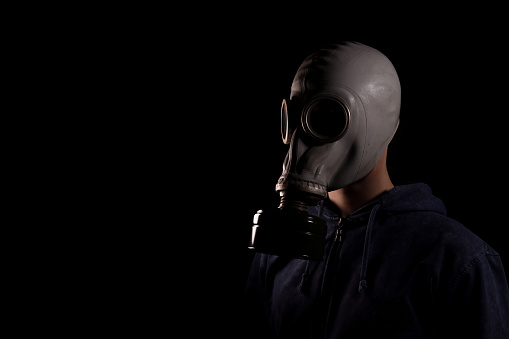 man in a gas mask, the concept of air pollution, the environment with chemicals