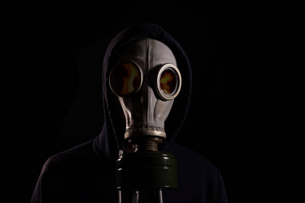 a-man-in-a-hood-in-a-gas-mask-with-a-reflection-of-fire-in-the-glasses-the-concept-of-a-fire.jpg