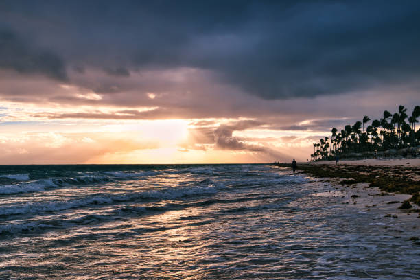 Punta Cana, Dominican Republic - February 20, 2023. Sunrise view over the caribbean sea. Sunbeams break through the clouds horizon