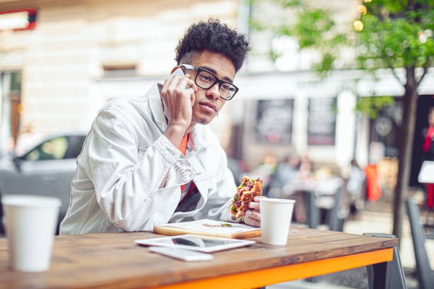 istock Young man having lunch in the city 1471456245