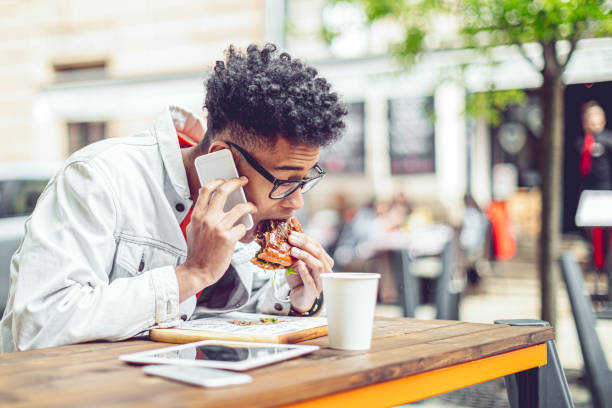 istock Young man having lunch in the city 1471456261
