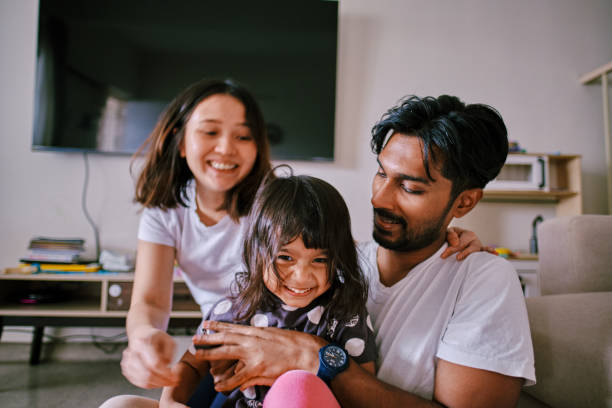 istock Beautiful Multiracial Parents Playing with Their Daughter 1471456408