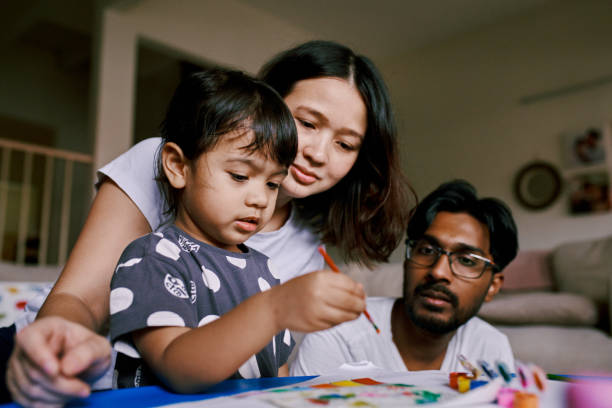 istock Multiracial Parents Colouring and Drawing with Their Daughter 1471456500