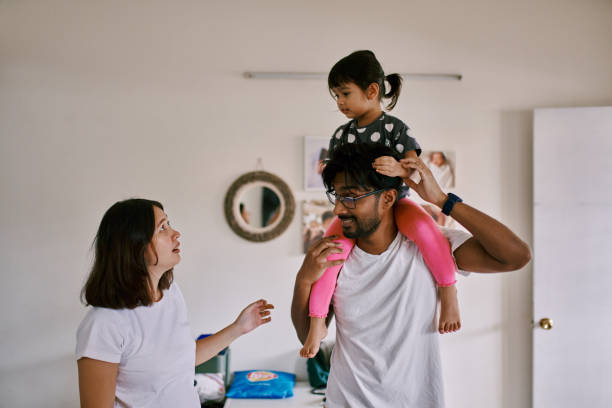 istock Playful Multiracial Parents with Their Daughter 1471456506