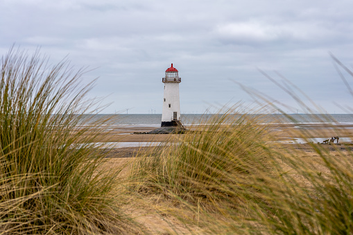 Talacre beach Point of Ayr light house peaking out above sand dunes and grasses.