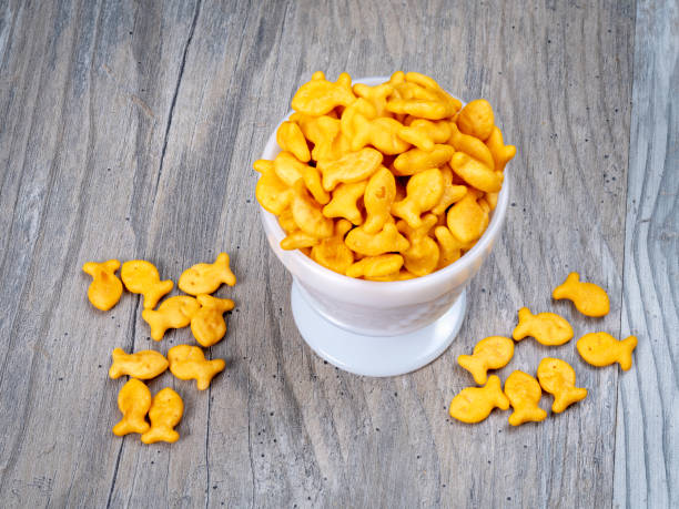 istock Orange cheddar flavored soup crackers in a white bowl 1471458258