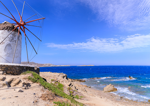 The windmill on the landmark hill in Chora  of the village of Mykonos: the windimills are iconic feature of the Greek island of Mykonos, one of the Cyclades islands in the Aegean Sea.