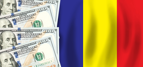 Dollars on flag of Romania, Romanian finance, subsidies, social support, GDP concept