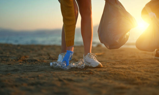 istock Mother with daughter saving the planet from garbage. 1471462741