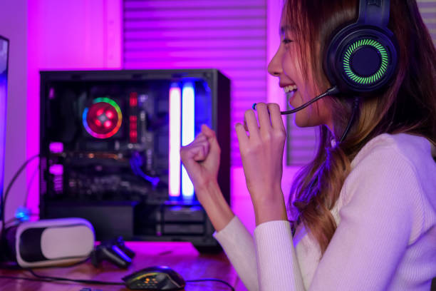 istock Young woman wearing headphones playing computer game 1471464337