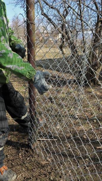 istock tension of the galvanized mesh when installing the fence 1471467193