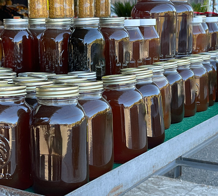 Roadside farm stand with jars of honey on display