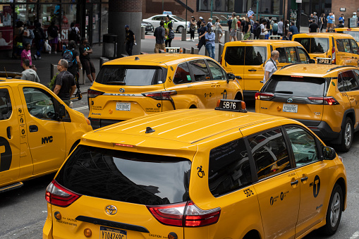 Brooklyn, NY - May 1 2022: Yellow retro taxi waiting in front of Box House Hotel in Greenpoint, Brooklyn, NY