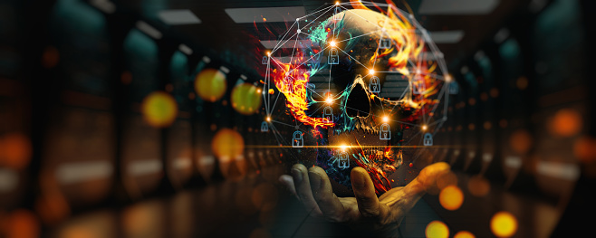 Businessman using computer skull icon on fire set up network connection with shield guard to protected from cyber attacks. Network security system concept