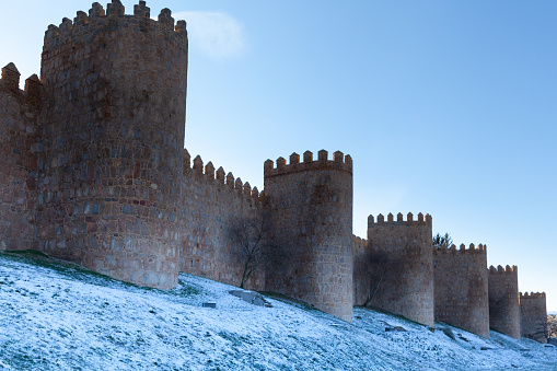 Avila, Spain - 6 January 2021: Medieval wall of Avila covered with snow