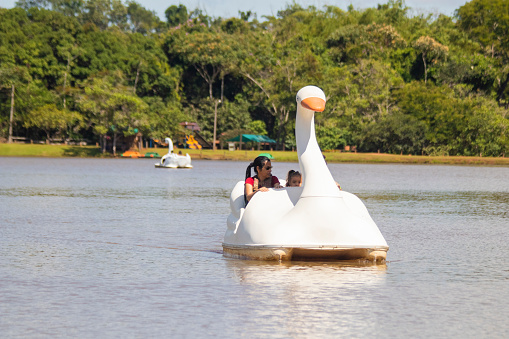 Brazilian people have fun in pedal boat on Teresopolis, 2022, Brazil.