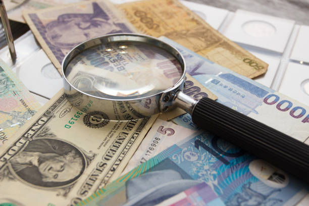 istock Different old collector's coins and magnifying glass 1471474689