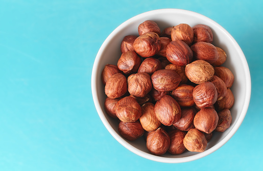 Close up picture of organic hazelnuts in a bowl, selective focus