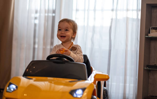 istock the baby rides in a toy car 1471475663