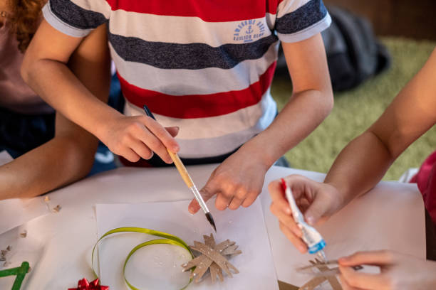 istock close up of children's hands making decorations for the Christmas tree 1471477447